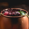 Bentwood Tavern in New Buffalo Michigan featured a cranberry mule cocktail at it's 2016 Thanksgiving dinner Cranberry mule cocktail in a copper mug, garnished with a lime wedge and four sugary cranberries on a toothpick