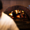 Bentwood Tavern, a waterfront restaurant on the New Buffalo, Michigan, harbor, features seasonal wood-fired pizzas Bentwood Tavern's brick wood fire pizza oven behind a line cook
