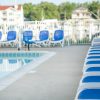 Guests of Marina Grand Resort in New Buffalo, Michigan, enjoy both indoor and outdoor pools, a Jacuzzi and a marina-side sundeck. Towel service is provided New Buffalo outdoor swimming pool surrounded by blue lounge chairs and overlooking the harbor
