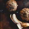 Marina Grand Resort's coffee market, Joe, features baked goods, barista-crafted coffee beverages and gourmet snacks. Hotel guests enjoy complimentary tea and locally-roasted coffee all day Half peeled banana and fresh blueberries next to a banana nut muffin and a blueberry muffin