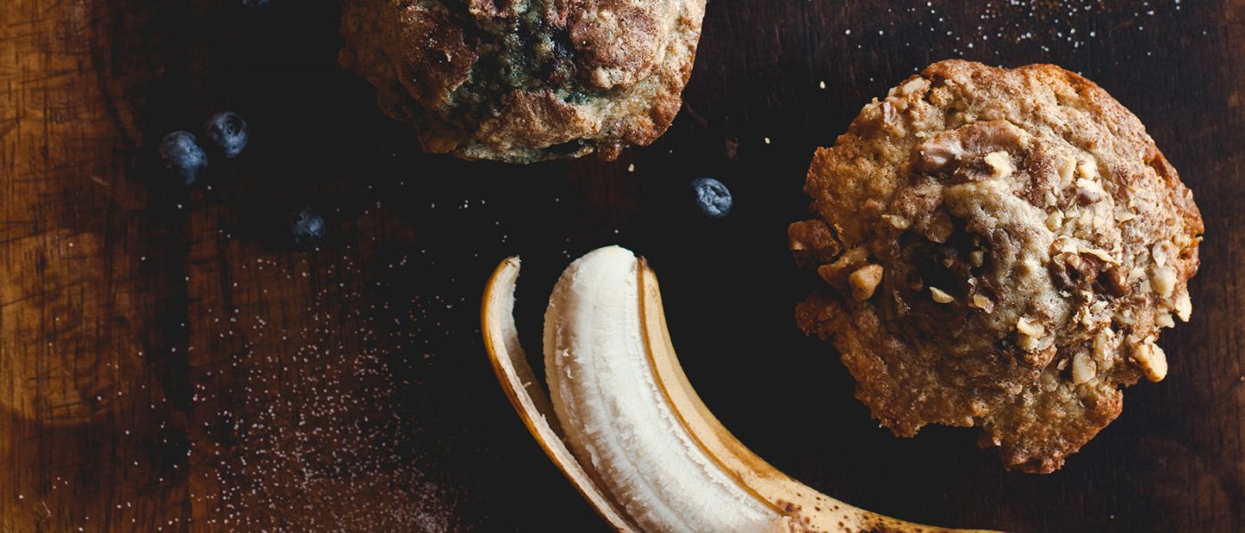 Marina Grand Resort's coffee market, Joe, features baked goods, barista-crafted coffee beverages and gourmet snacks. Hotel guests enjoy complimentary tea and locally-roasted coffee all day Half peeled banana and fresh blueberries next to a banana nut muffin and a blueberry muffin