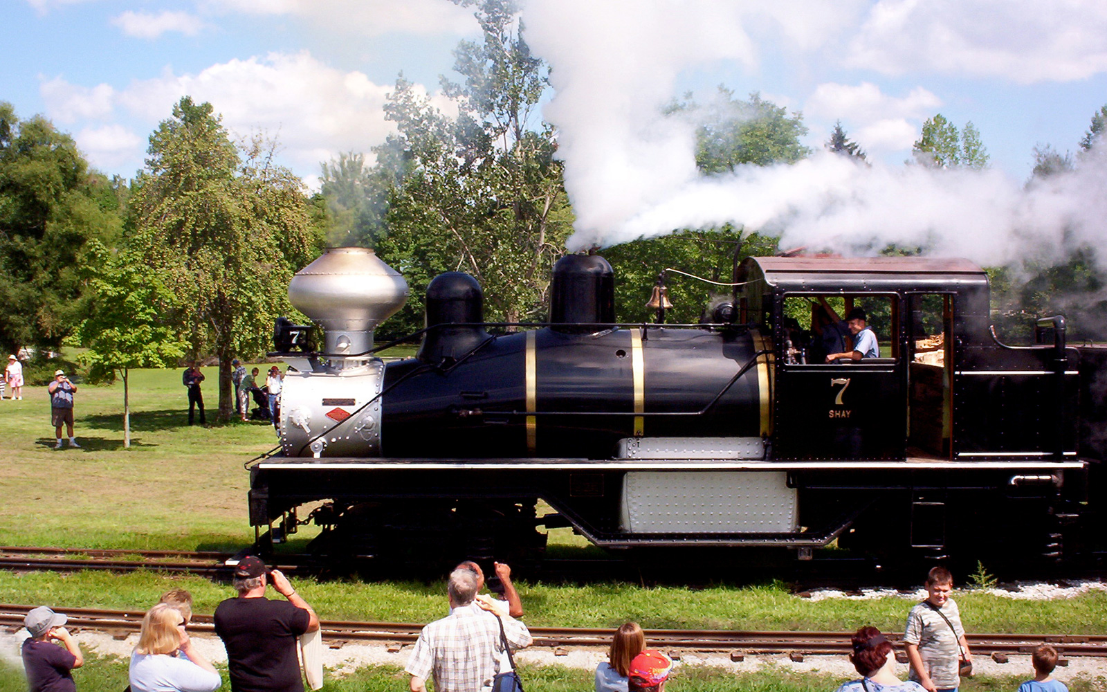 people gather to see a classic steam engine train at Hesston