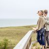 New Buffalo beach features a curvy wooden boardwalk with lovely views of Lake Michigan A mature caucasian couple standing on the wooden boardwalk and looking out over the beach grass and lake Michigan