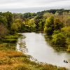 The Marina Grand Resort is situated in Harbor Country, where there are so many wonderful things to do in every season, including kayak the Galien River A couple kayaks the Galien River surrounded by trees and thick grasses in this drone aerial photo