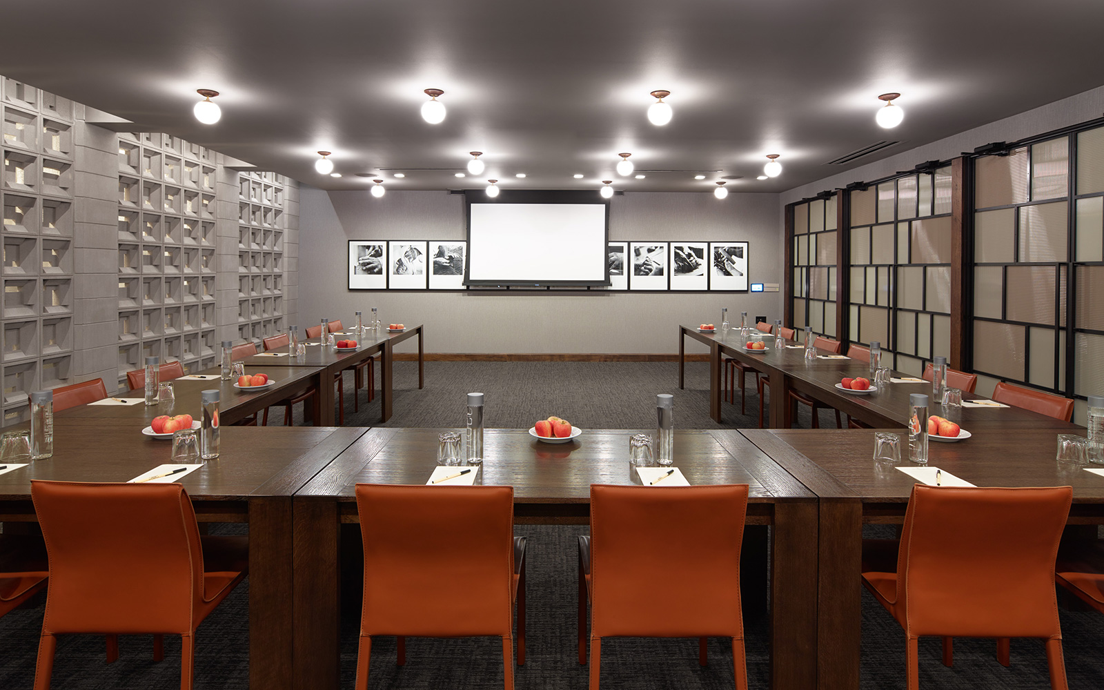 the Prairie Room at The Harbor Grand, a unique hotel meeting space with solid wood tables, a custom-made cement brick wall and projector screen