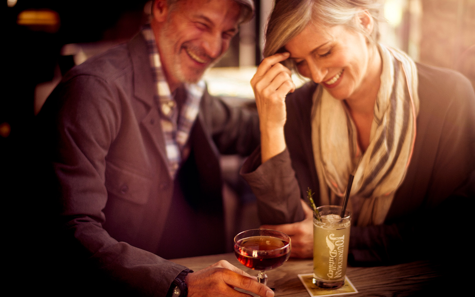 a smiling couple having a cocktail
