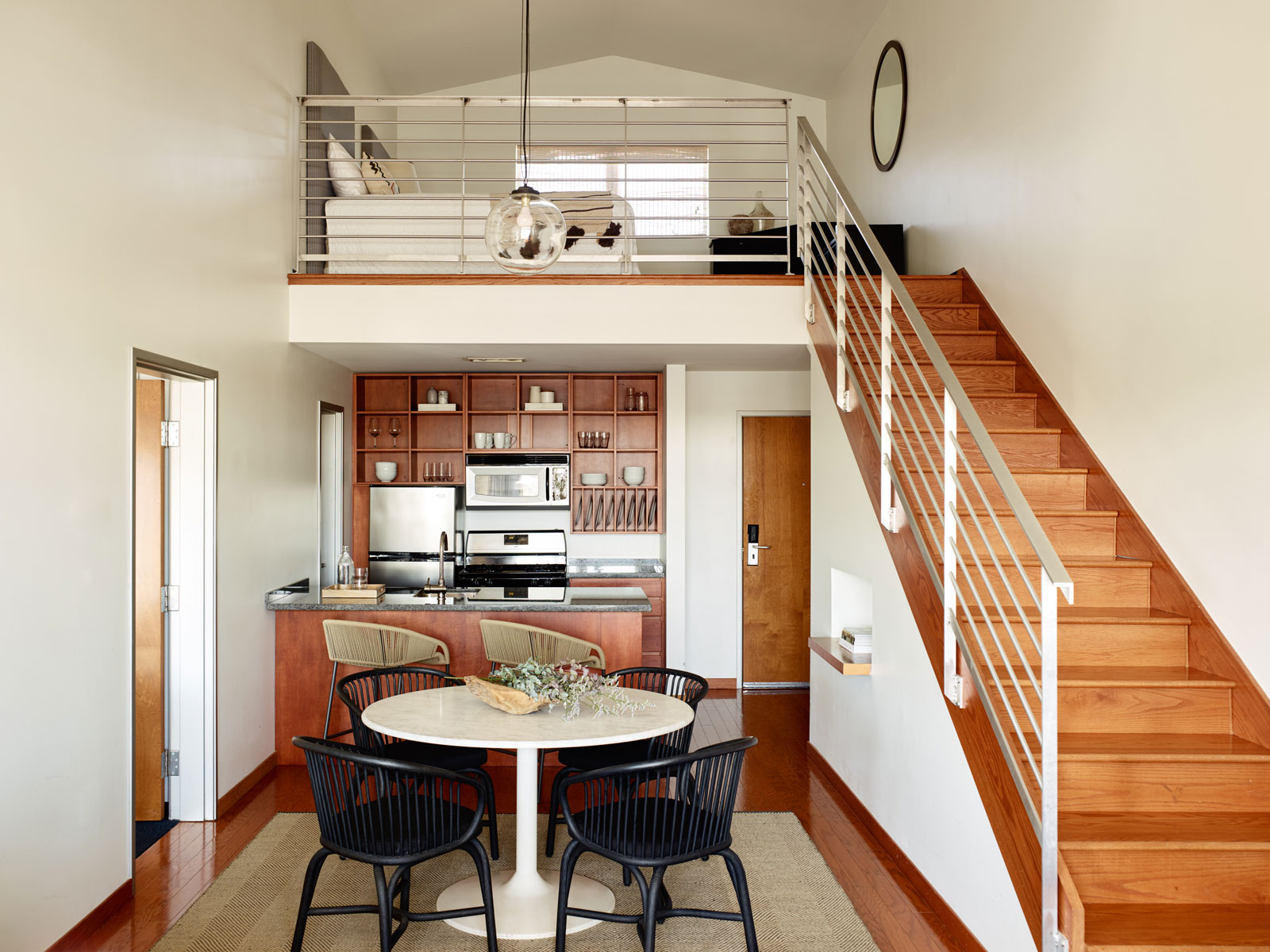 Open plan dining room and kitchen with stairs to the loft at Marina Grand Resort in New Buffalo, Michigan
